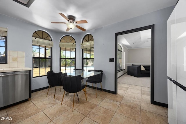 dining area featuring a ceiling fan and baseboards