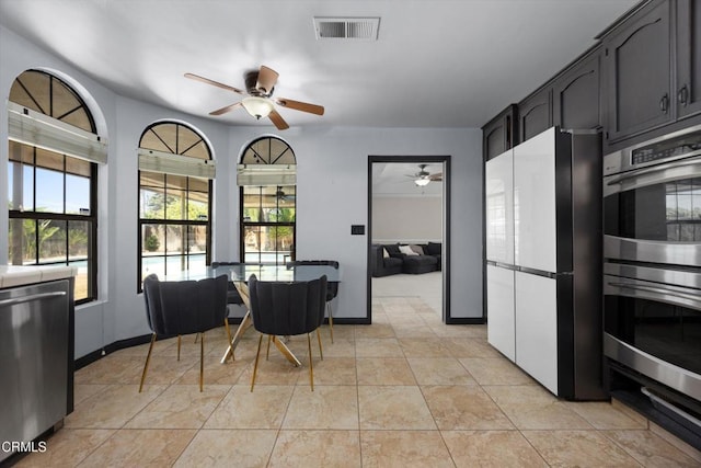 dining space featuring ceiling fan, plenty of natural light, and baseboards
