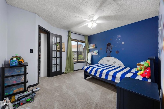 bedroom with carpet, a textured ceiling, ceiling fan, and baseboards