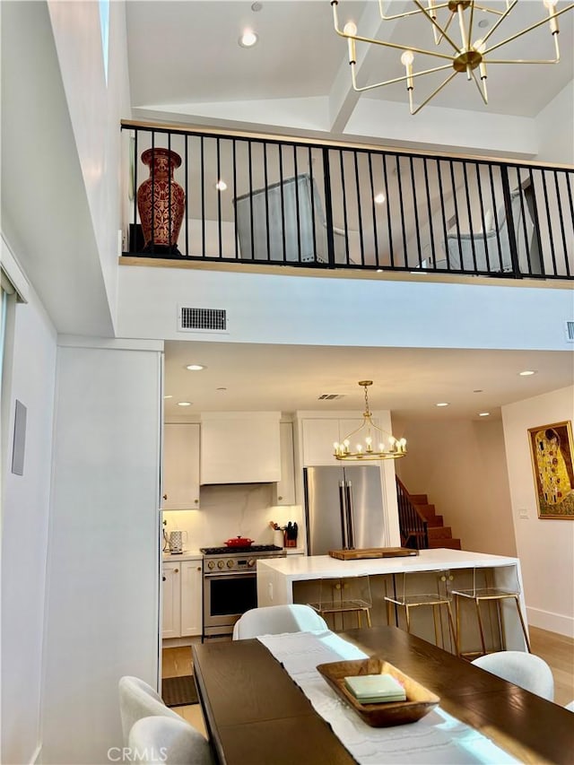 2621 Gates Ave Unit B, Redondo Beach, CA 90278 - dining area featuring a chandelier, a high ceiling, stairway, light wood-type flooring, and recessed lighting