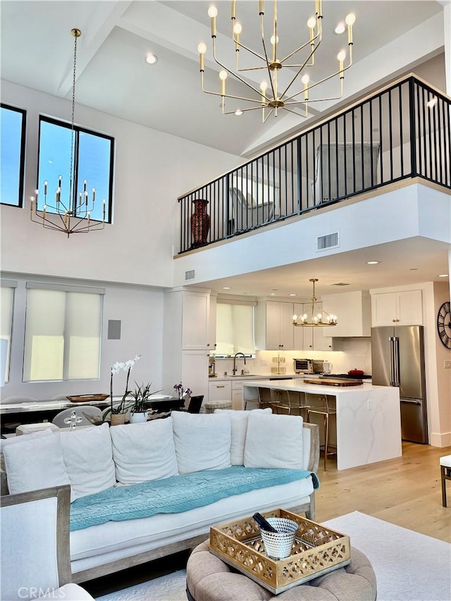 2621 Gates Ave Unit B, Redondo Beach, CA 90278 - living room with a chandelier, a high ceiling, light wood-type flooring, and recessed lighting
