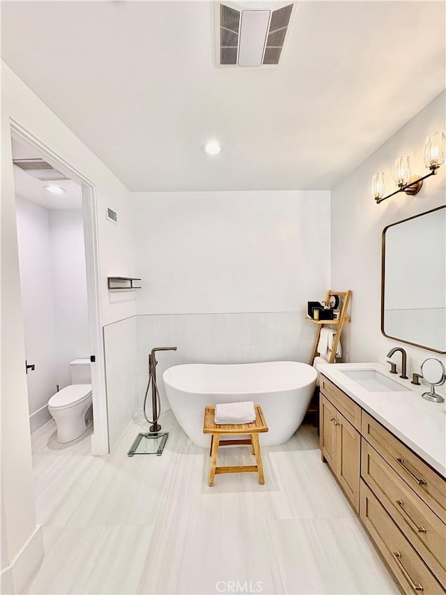 2621 Gates Ave Unit B, Redondo Beach, CA 90278 - bathroom featuring vanity, toilet, a soaking tub, recessed lighting, and tile walls