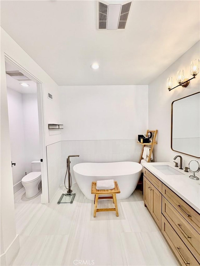 2621 Gates Ave Unit B, Redondo Beach, CA 90278 - bathroom with vanity, a freestanding bath, recessed lighting, and tile walls