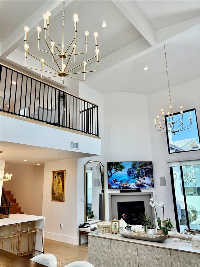 2621 Gates Ave Unit B, Redondo Beach, CA 90278 - living area featuring a chandelier, a towering ceiling, stairway, light wood-style floors, and beam ceiling