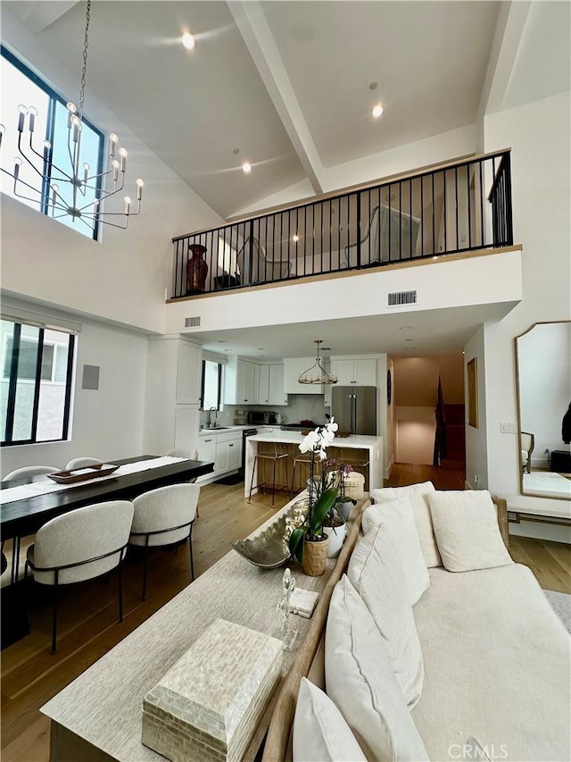 2621 Gates Ave Unit B, Redondo Beach, CA 90278 - dining room featuring high vaulted ceiling, light wood finished floors, beam ceiling, a chandelier, and healthy amount of natural light