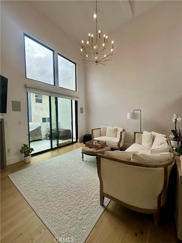 2621 Gates Ave Unit B, Redondo Beach, CA 90278 - living room featuring high vaulted ceiling, a chandelier, light wood-type flooring, and baseboards