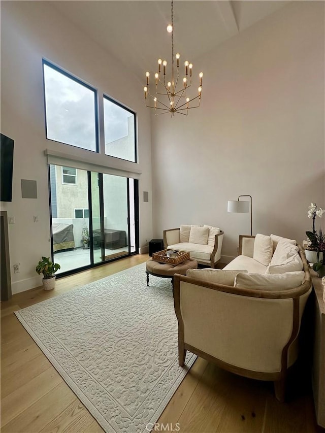 2621 Gates Ave Unit B, Redondo Beach, CA 90278 - living room featuring high vaulted ceiling, a chandelier, and light wood-style flooring