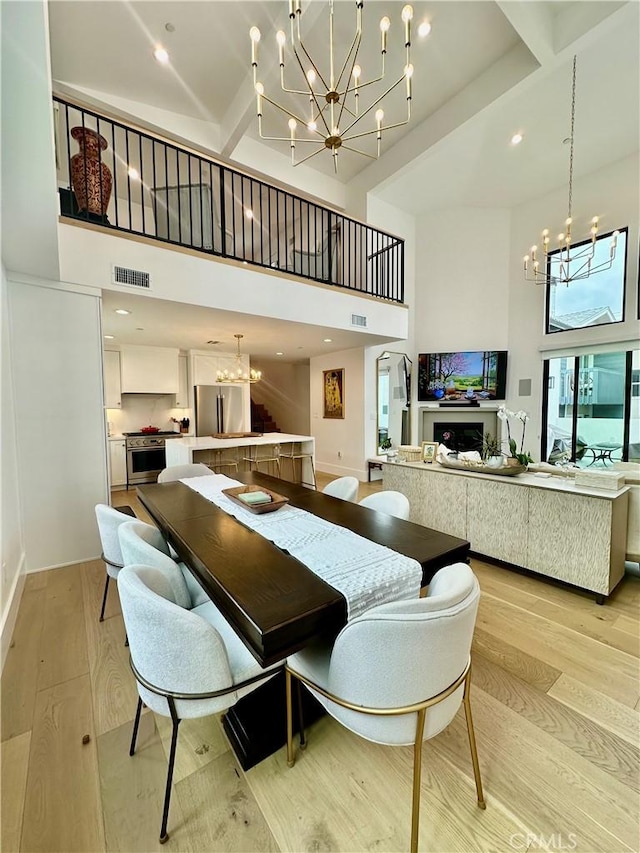 2621 Gates Ave Unit B, Redondo Beach, CA 90278 - dining space with a chandelier, a high ceiling, light wood-style flooring, recessed lighting, and baseboards