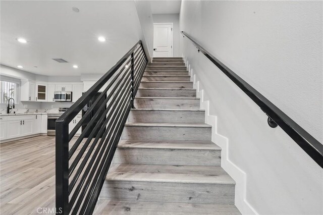1643 W 82nd St, Los Angeles, CA 90047 - staircase featuring recessed lighting and wood finished floors