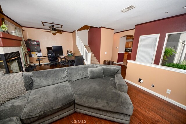 3509 E Berkshire Ct Unit C, Orange, CA 92869 - living area featuring ceiling fan, arched walkways, a glass covered fireplace, baseboards, and ornamental molding