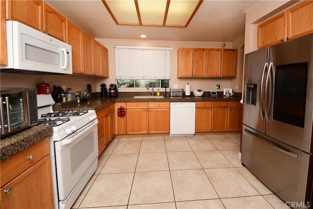 3509 E Berkshire Ct Unit C, Orange, CA 92869 - kitchen featuring white appliances, a sink, dark countertops, recessed lighting, and light tile patterned floors