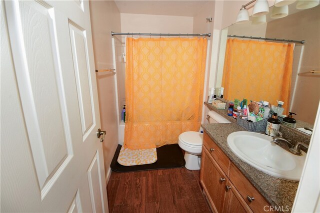 3509 E Berkshire Ct Unit C, Orange, CA 92869 - full bathroom featuring wood finished floors, vanity, toilet, and shower / bath combo with shower curtain