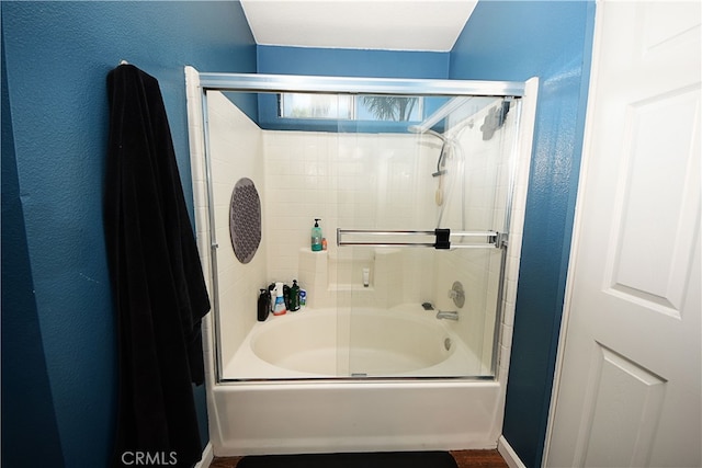 3509 E Berkshire Ct Unit C, Orange, CA 92869 - bathroom featuring combined bath / shower with glass door and a textured wall