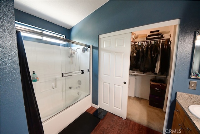 3509 E Berkshire Ct Unit C, Orange, CA 92869 - full bathroom featuring vaulted ceiling, enclosed tub / shower combo, wood finished floors, vanity, and a walk in closet