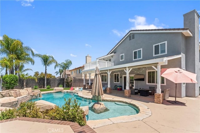 view of swimming pool with a patio area, a fenced backyard, and an outdoor living space