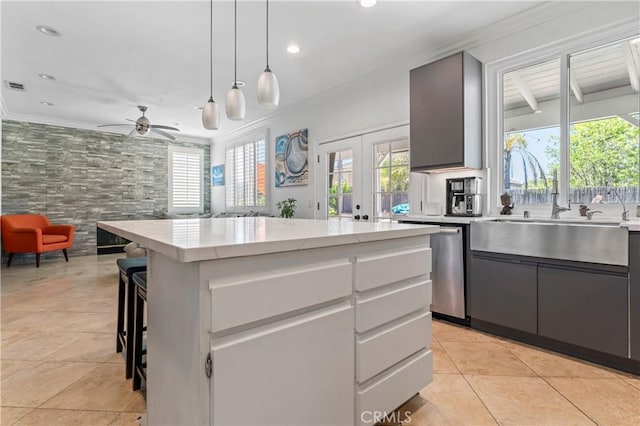 kitchen with light tile patterned floors, recessed lighting, decorative light fixtures, a ceiling fan, and ornamental molding
