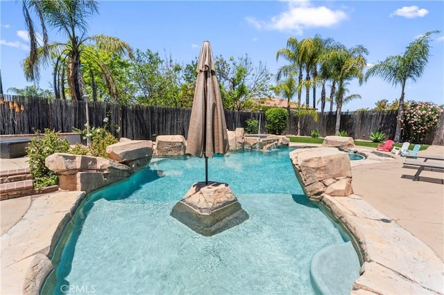 view of pool with an outdoor hot tub, a fenced backyard, and a patio area