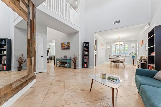 8489 Syracuse St, Riverside, CA 92508 - living area with ornamental molding, a towering ceiling, a chandelier, and light tile patterned flooring