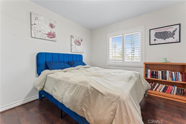 bedroom with wood finished floors and baseboards