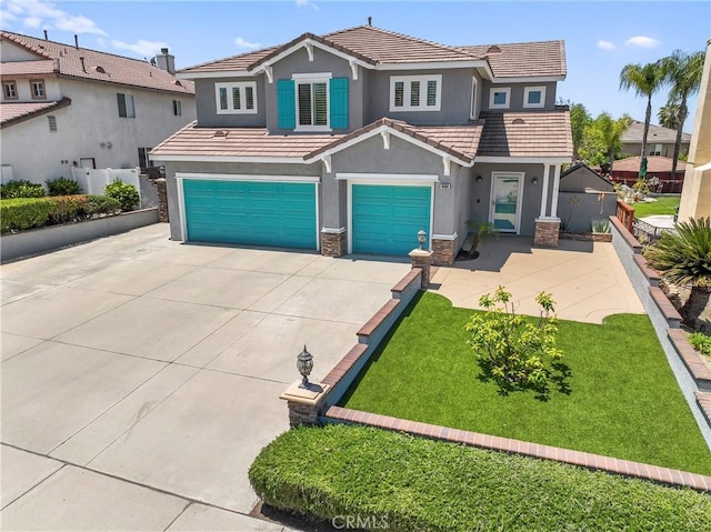 view of front of home with concrete driveway, an attached garage, stucco siding, stone siding, and a tile roof