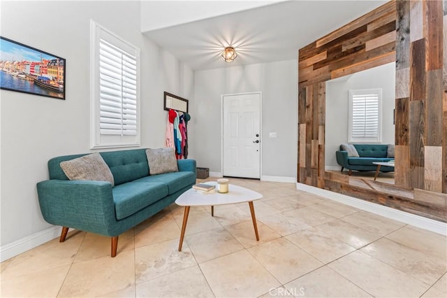 tiled living room featuring baseboards