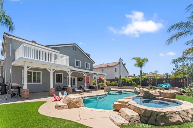 view of swimming pool with an in-ground hot tub, a fenced backyard, and a patio area