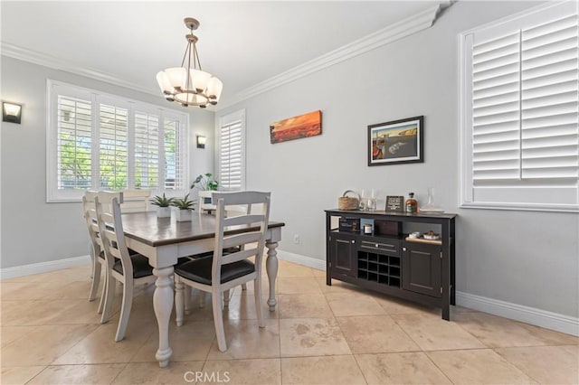 dining area featuring ornamental molding, a chandelier, baseboards, and light tile patterned floors