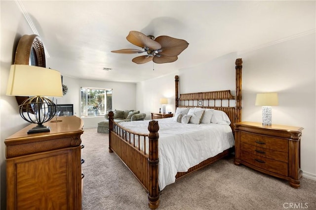 bedroom featuring light carpet, baseboards, and ceiling fan
