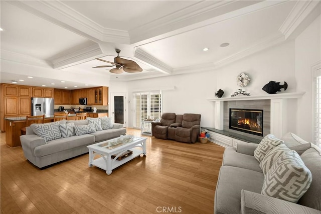 living area featuring a high end fireplace, coffered ceiling, light wood finished floors, ceiling fan, and beam ceiling