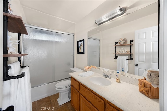 full bathroom featuring vanity, enclosed tub / shower combo, toilet, and tile patterned floors