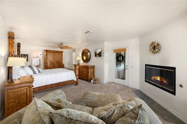 carpeted bedroom featuring a glass covered fireplace, a ceiling fan, and ornamental molding