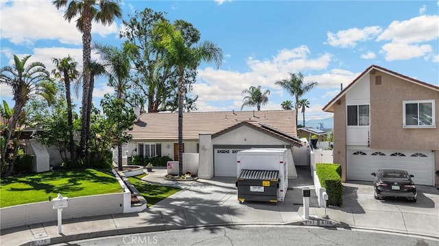 view of front of property featuring driveway and stucco siding