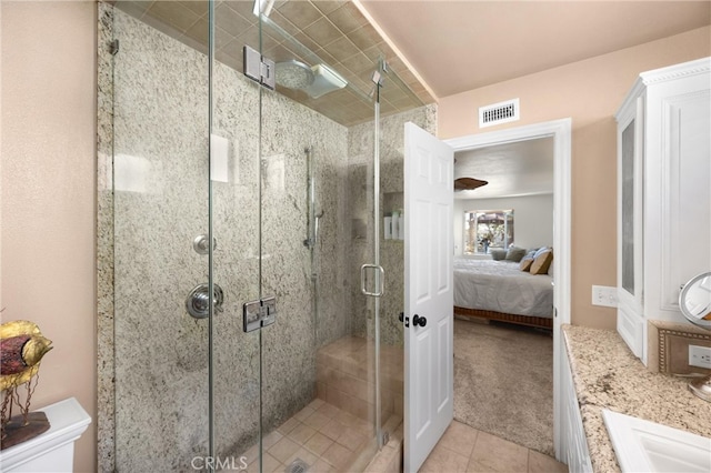 full bathroom featuring ensuite bathroom, a stall shower, and tile patterned flooring