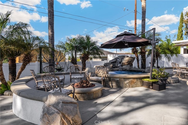 view of patio / terrace with a fire pit and a fenced backyard
