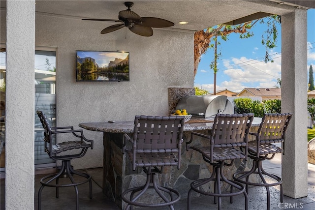 view of patio / terrace with exterior kitchen, ceiling fan, and grilling area