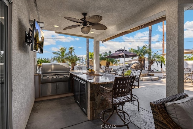 view of patio with area for grilling and a ceiling fan
