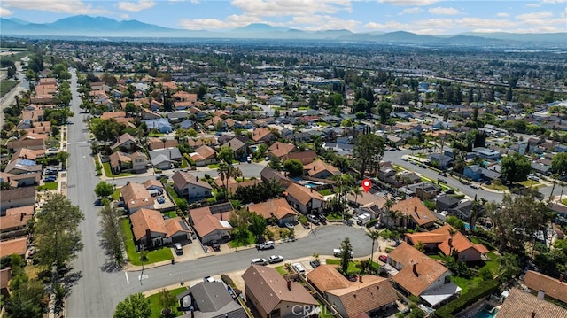 aerial overview of property's location with a mountainous background and nearby suburban area