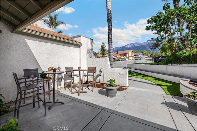 view of patio / terrace with a mountain view and outdoor dining area