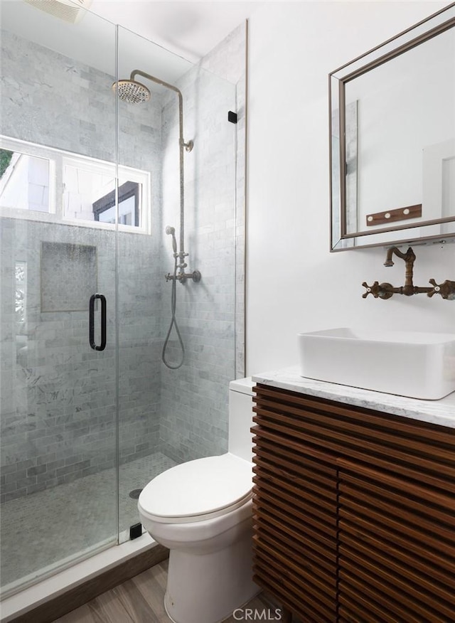 565 Lombardy Ln, Laguna Beach, CA 92651 - bathroom with toilet, a stall shower, wood finished floors, and vanity