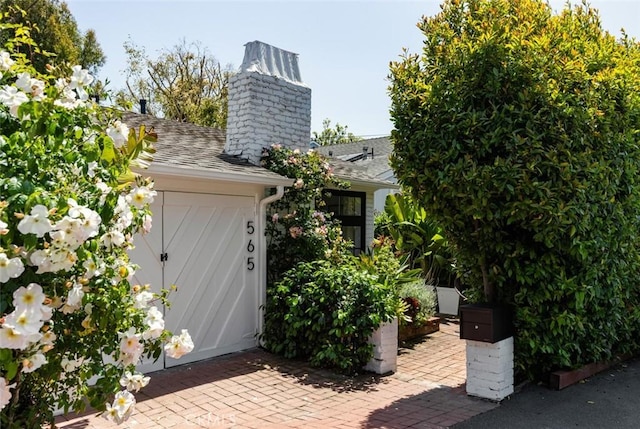565 Lombardy Ln, Laguna Beach, CA 92651 - view of front facade with a chimney and roof with shingles