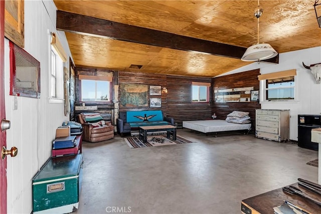 bedroom with wood walls, finished concrete flooring, and lofted ceiling
