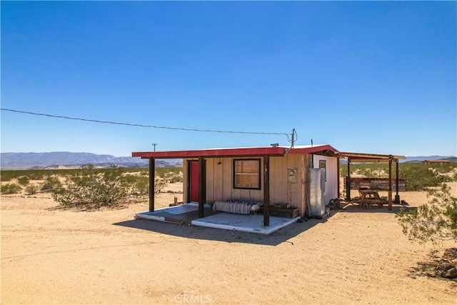 view of outbuilding featuring a mountain view