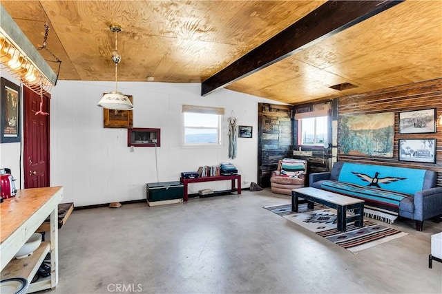 living area with plenty of natural light, concrete floors, wood walls, wooden ceiling, and vaulted ceiling