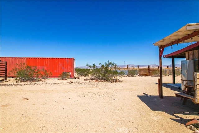 view of yard with fence and a mountain view