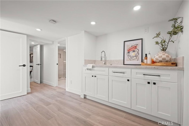 4160 Hubbard St, Los Angeles, CA 90023 - bar featuring a sink, light wood-type flooring, baseboards, and recessed lighting