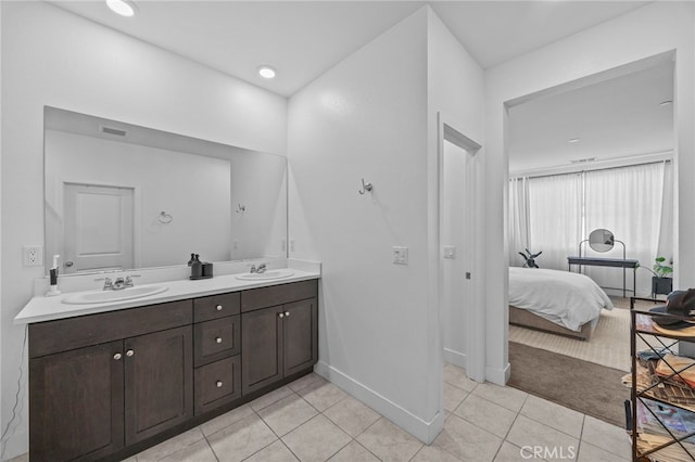 62892 Loftwood St, Desert Hot Springs, CA 92240 - ensuite bathroom featuring tile patterned floors, double vanity, and baseboards