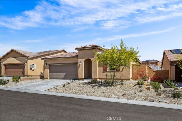 62892 Loftwood St, Desert Hot Springs, CA 92240 - view of front facade featuring stucco siding, a garage, concrete driveway, a tiled roof, and fence