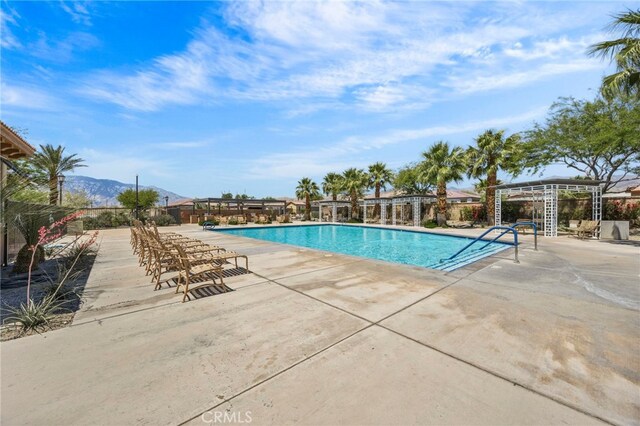 62892 Loftwood St, Desert Hot Springs, CA 92240 - community pool with a patio and a mountain view