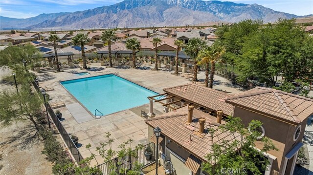 62892 Loftwood St, Desert Hot Springs, CA 92240 - community pool with a residential view, a patio, a mountain view, and fence