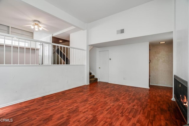 4213 Sarah St Unit 22, Burbank, CA 91505 - unfurnished living room featuring wood finished floors, a ceiling fan, stairs, a fireplace, and a towering ceiling